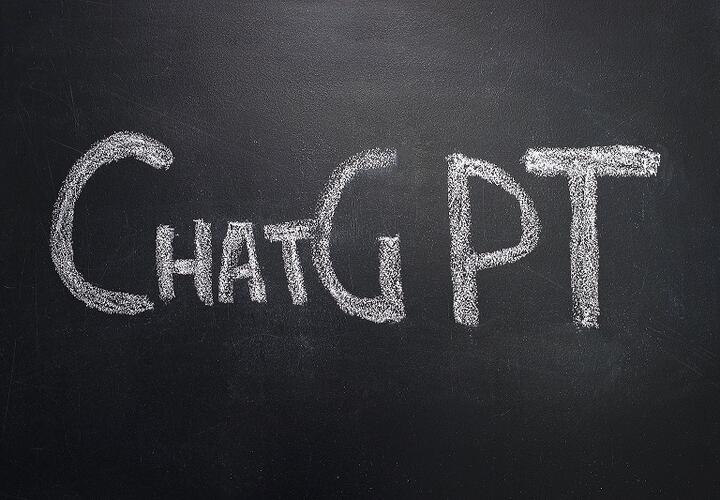 A chalkboard surface reads "ChatGPT" in large, chalked letters.